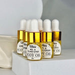 Six small gold bottles on a white platform in front of a white background