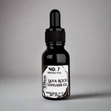 Black glass bottle for lava rock diffuser oil on a white background