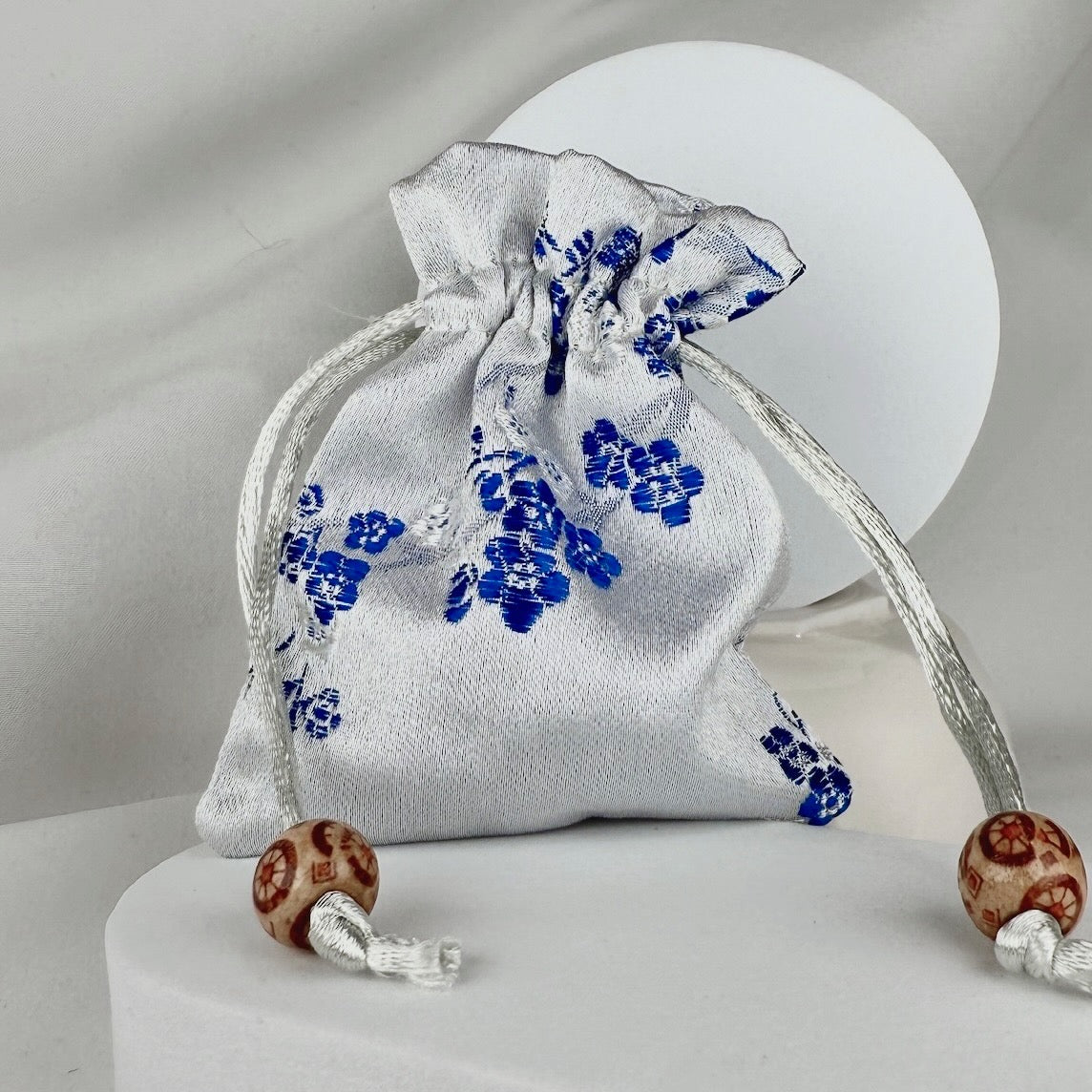 White and blue silk sachet on a white background
